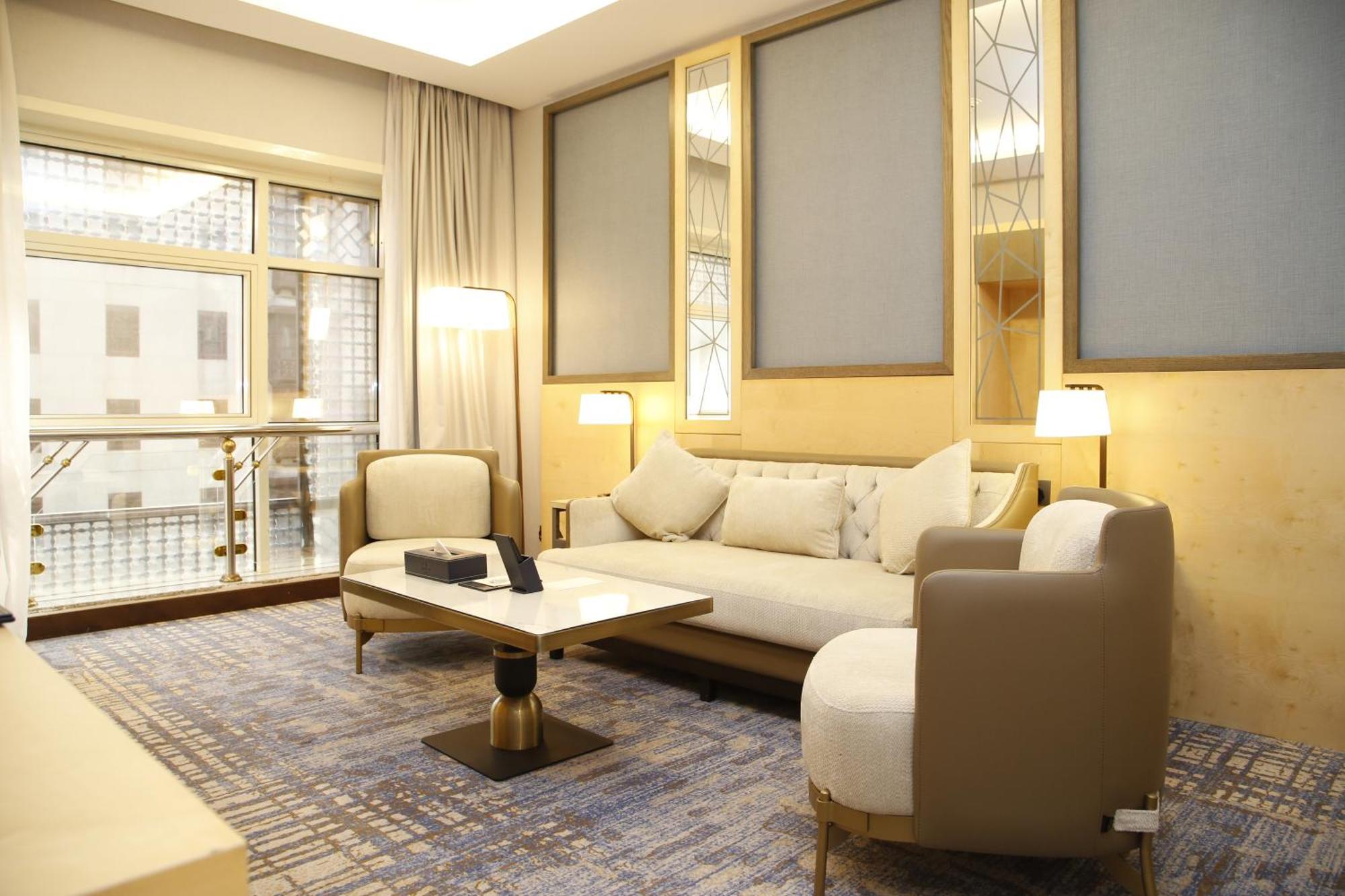 Maden Alrawda Hotel Medina Exterior photo A living room in a suite at the Ritz-Carlton, DIFC